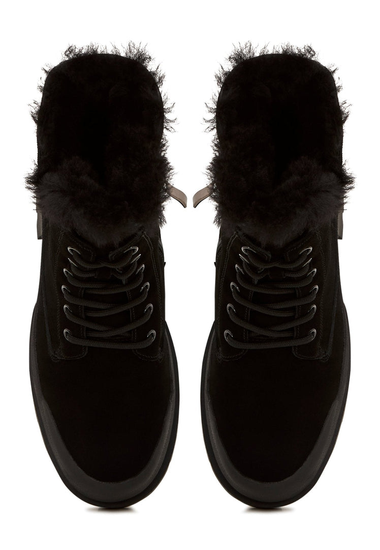 A stylish pair of black suede ankle boots, perfect for a fashionable and sophisticated look.