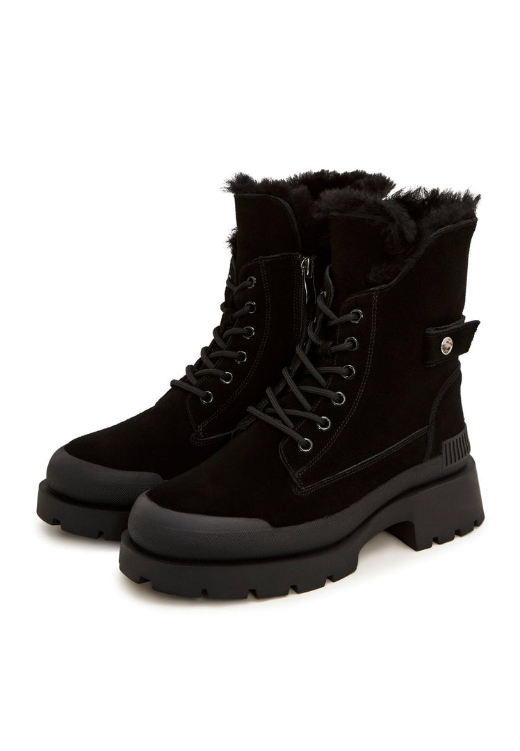 A pair of fashionable black suede ankle boots, the epitome of elegance and style in footwear.