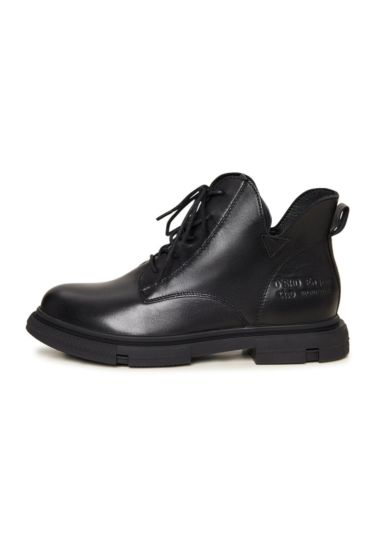 A pair of stylish black leather women's flat sole ankle boots with a chic design, perfect for everyday wear.