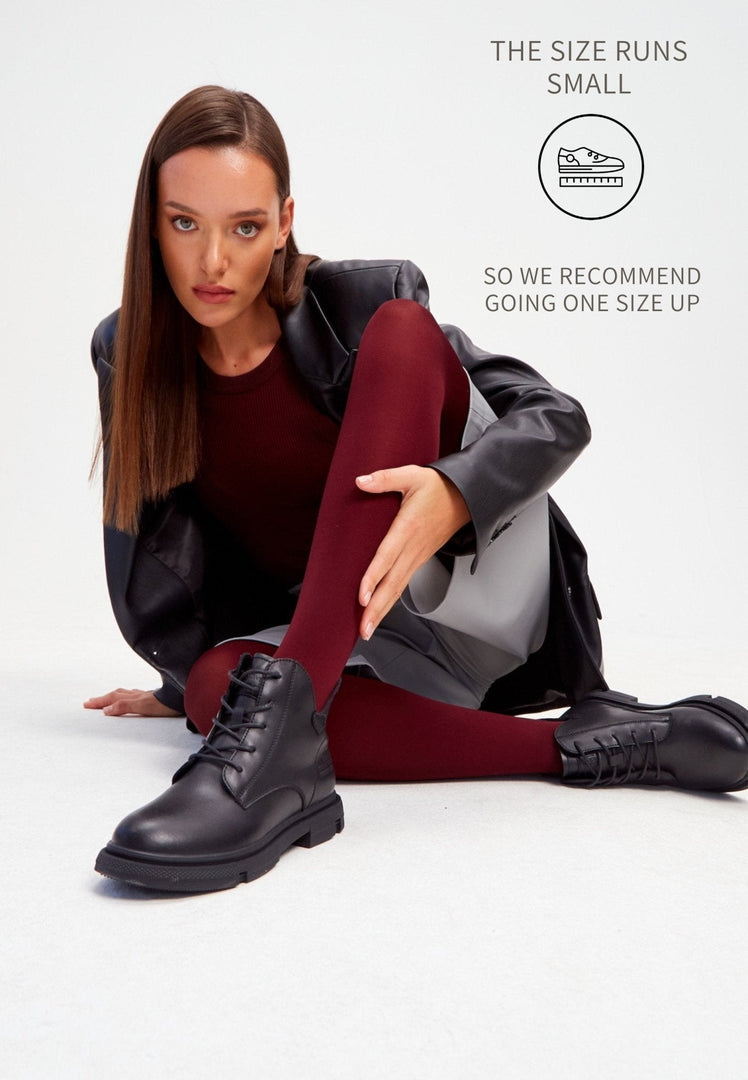 A stylish pair of black leather flat sole ankle boots for women, perfect for a comfortable and chic look.