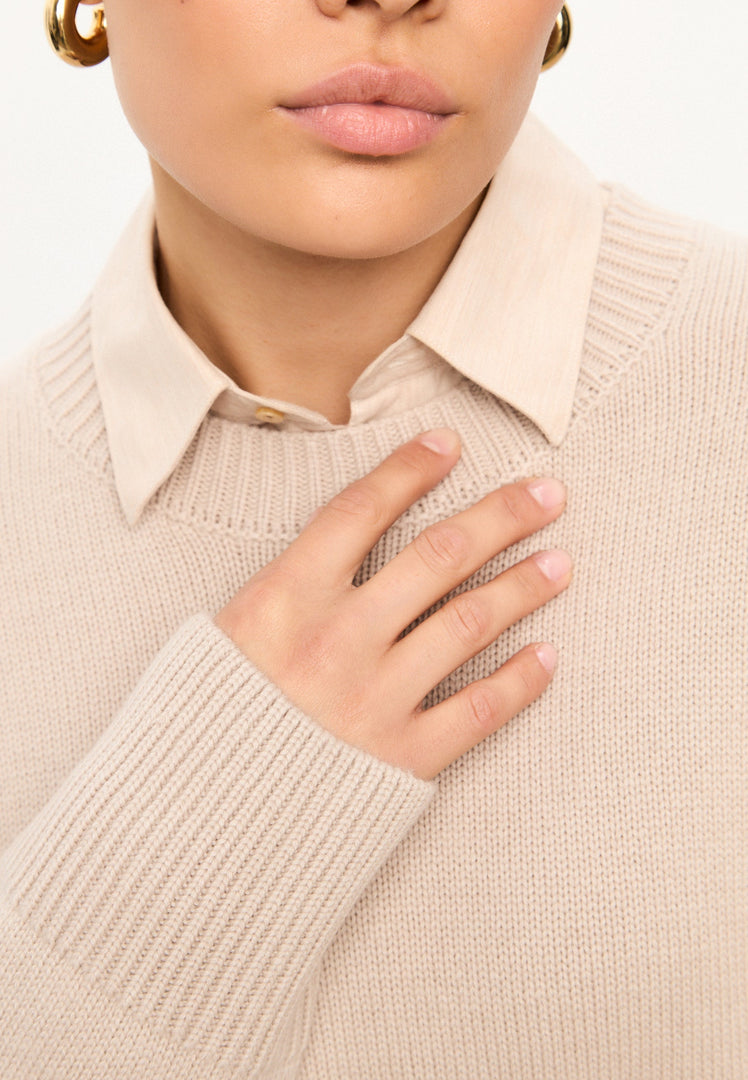 A stylish beige women's knit pullover sweater with a classic crew neck design, inspired by Mulan.