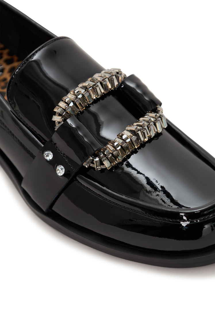 Black patent loafers with crystal embellishments, also known as Bagheera loafers, are elegant and sophisticated black embellished shoes perfect for any occasion.