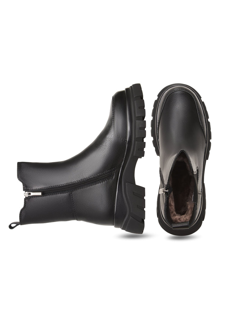 A stylish pair of black Göll ankle boots, the perfect fashion statement with a bold and sleek design.