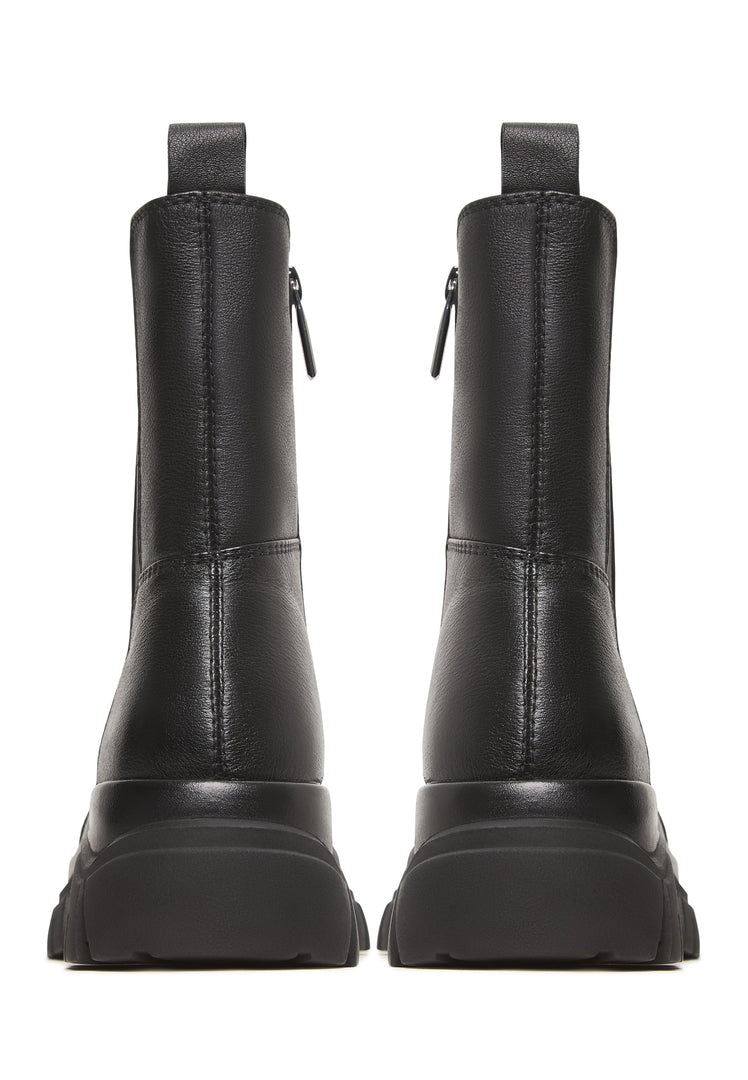 A stylish pair of black Göll ankle boots, perfect for fashion-forward individuals looking for bold and trendy footwear.