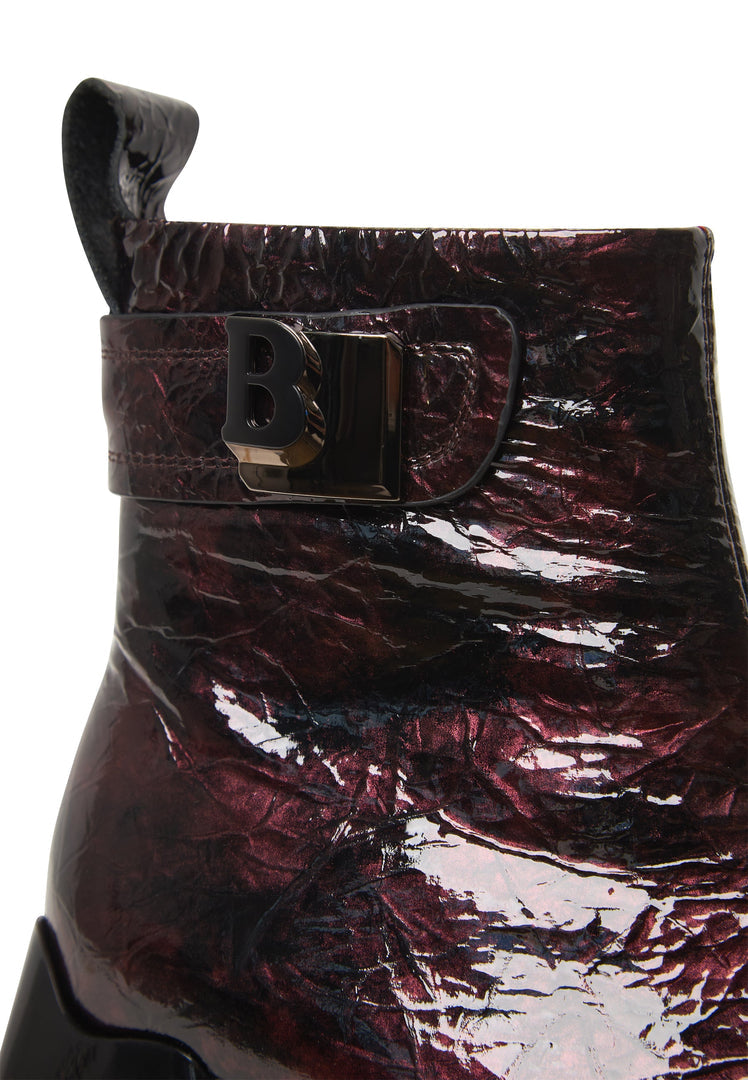 A stylish pair of women's Bordeaux leather ankle boots, known as Vika boots, characterized by their sleek design.