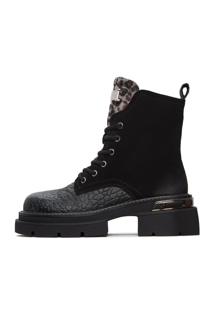 A chic pair of black suede Luna ankle boots with platform heels, a modern twist on classic leather ankle boots.