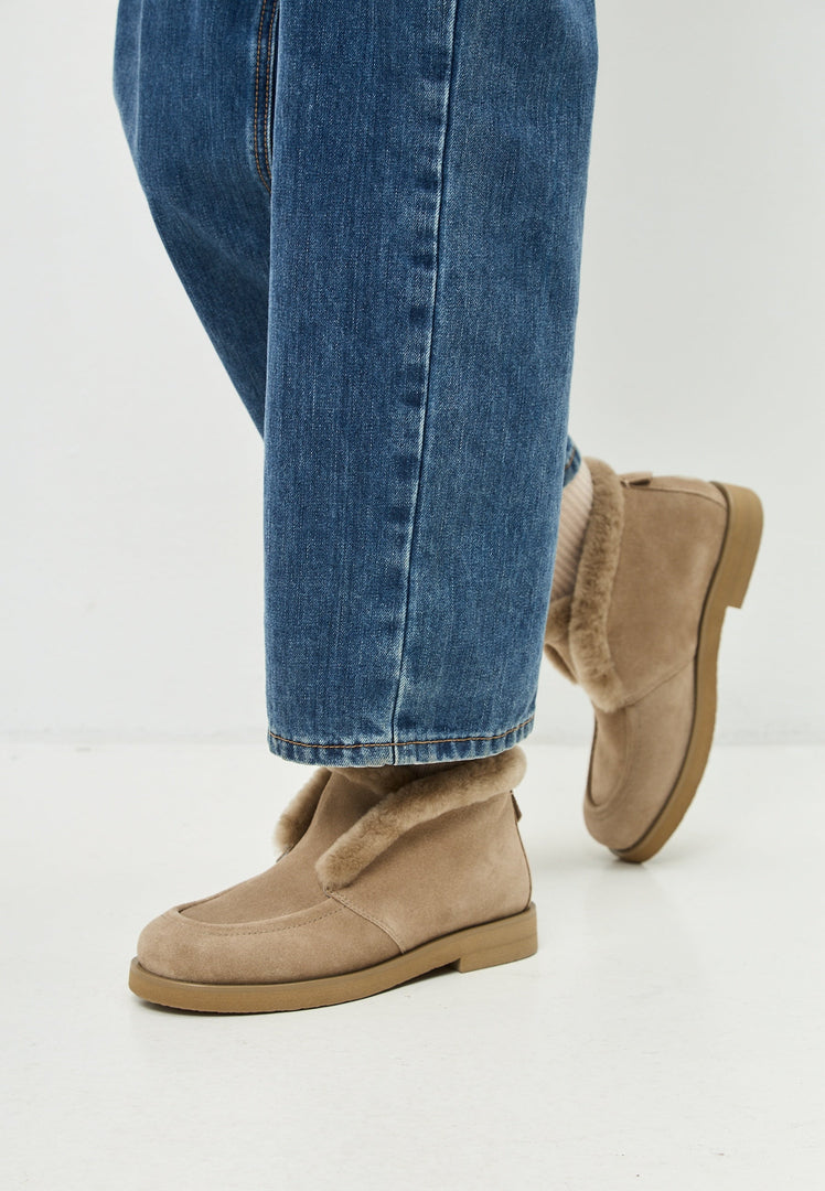 A pair of beige Antonia winter ankle boots, perfect for stylish women's winter fashion.