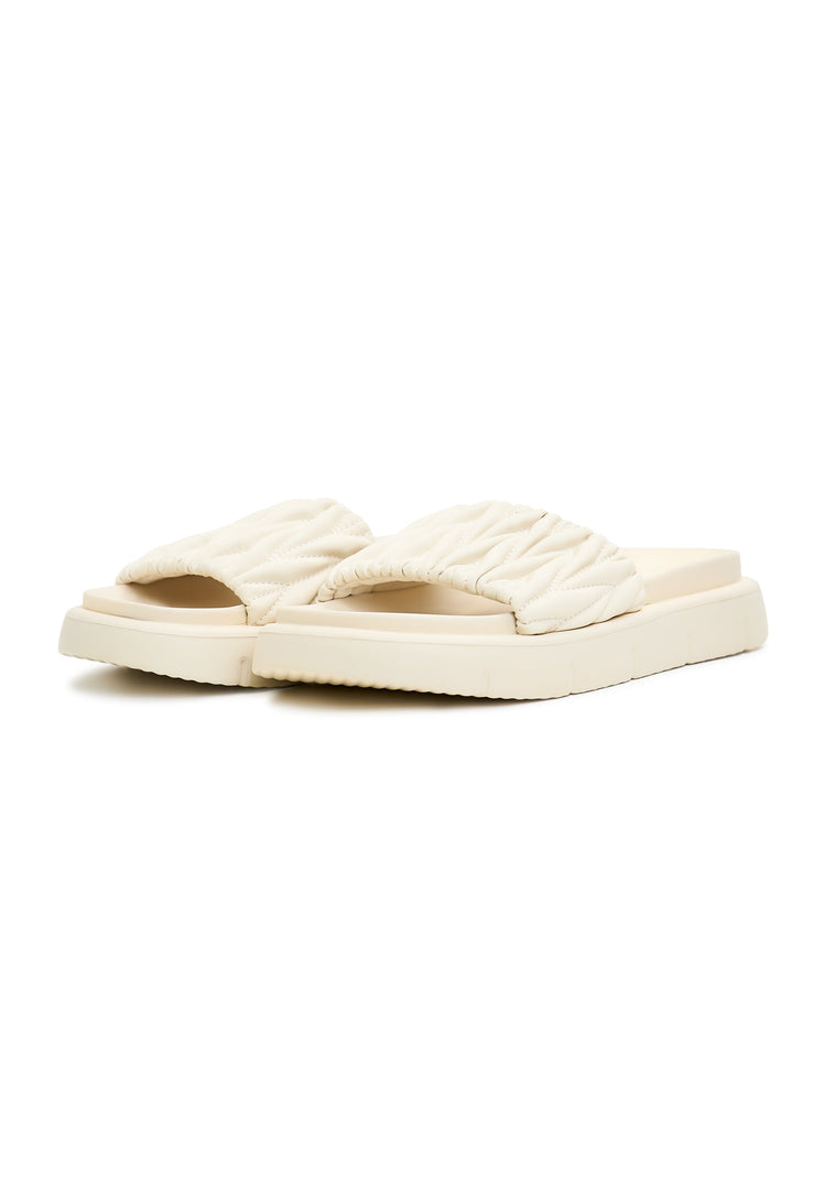 A pair of trendy beige Mirena leather sandals for women, the perfect fashion statement for summer leather footwear enthusiasts.