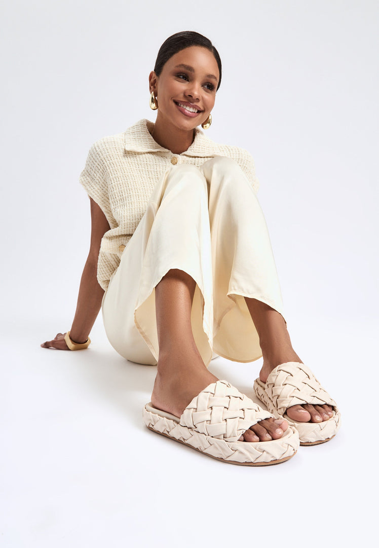 A trendy pair of beige platform slippers, the Antonella platform sandals, perfect for women seeking stylish beige footwear that's both fashionable and comfortable.