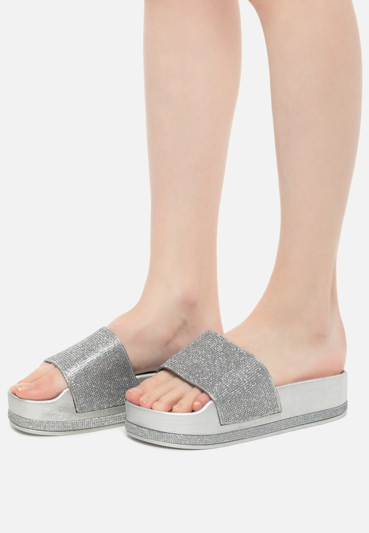 A stylish pair of silver platform flip flops for women's fashion, featuring trendy silver sandals.
