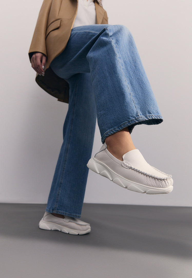 A stylish pair of white leather Alisa moccasins with platform soles for women.