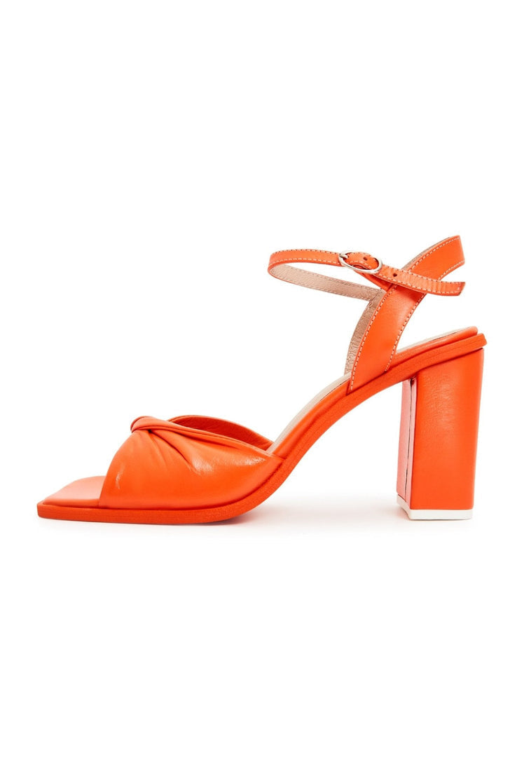 A pair of timeless orange block heels, the perfect addition to any woman's footwear collection for classic style.