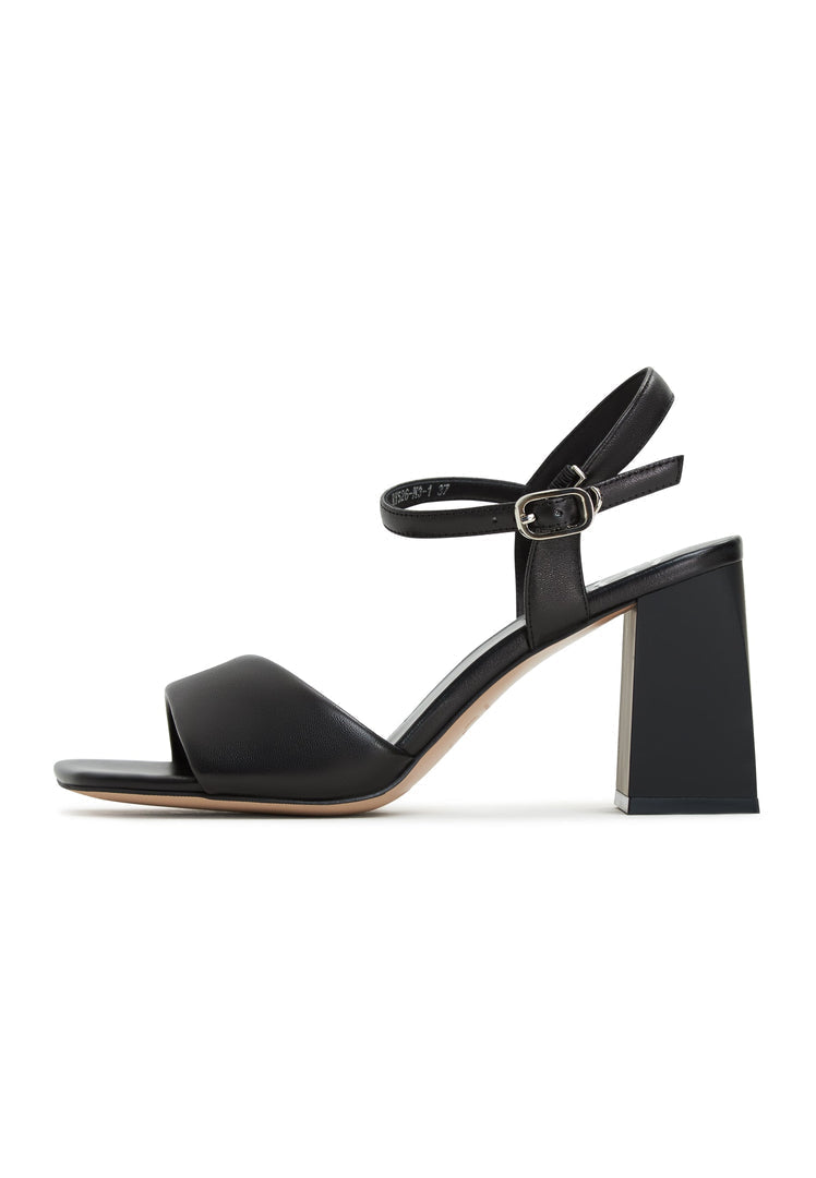 A pair of stylish black open-toe block heeled sandals, the Aina black sandals, perfect for fashion-forward women's heeled shoe lovers.