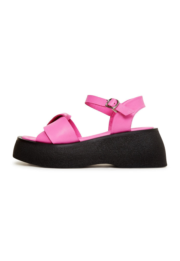 A stylish pair of women's fuchsia leather platform sandals with high heels, perfect for a fashion-forward look.