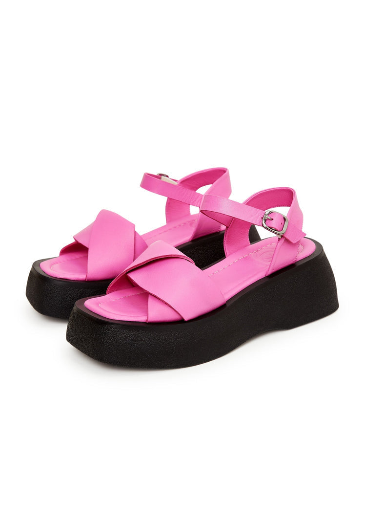A stylish pair of designer fuchsia leather platform sandals for women with a high heel design.