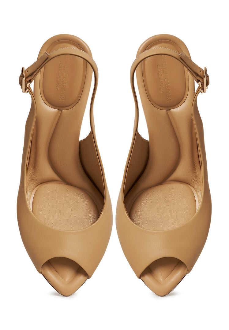 A fashionable pair of beige Mariana high heeled sandals with elegant stiletto heels, a perfect choice for designer footwear lovers.