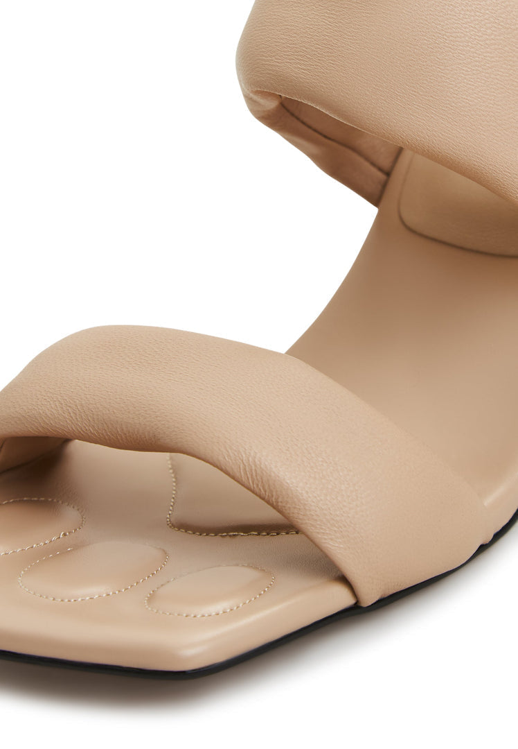A pair of stylish Isla block heeled beige sandals for women - perfect summer footwear.