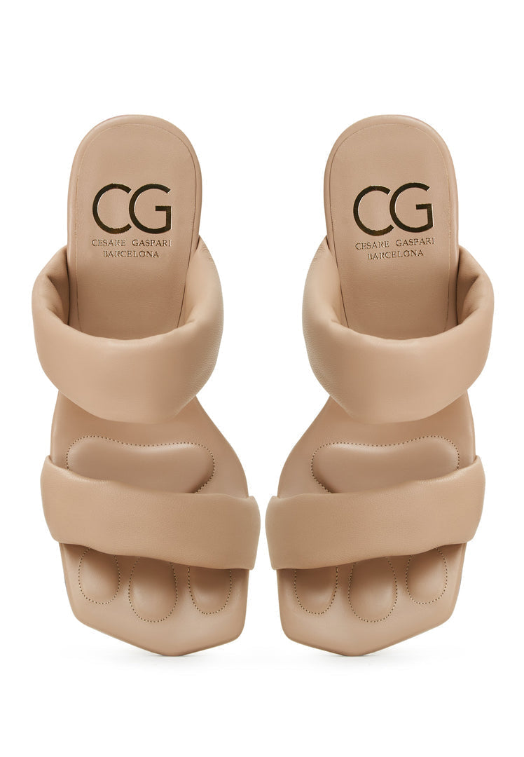A pair of stylish women's Isla block heeled beige sandals, perfect for summer footwear fashion.