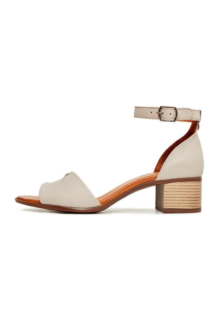 A stylish pair of beige block heeled sandals, perfect for women looking for neutral chunky heel sandals in a fashionable beige color.