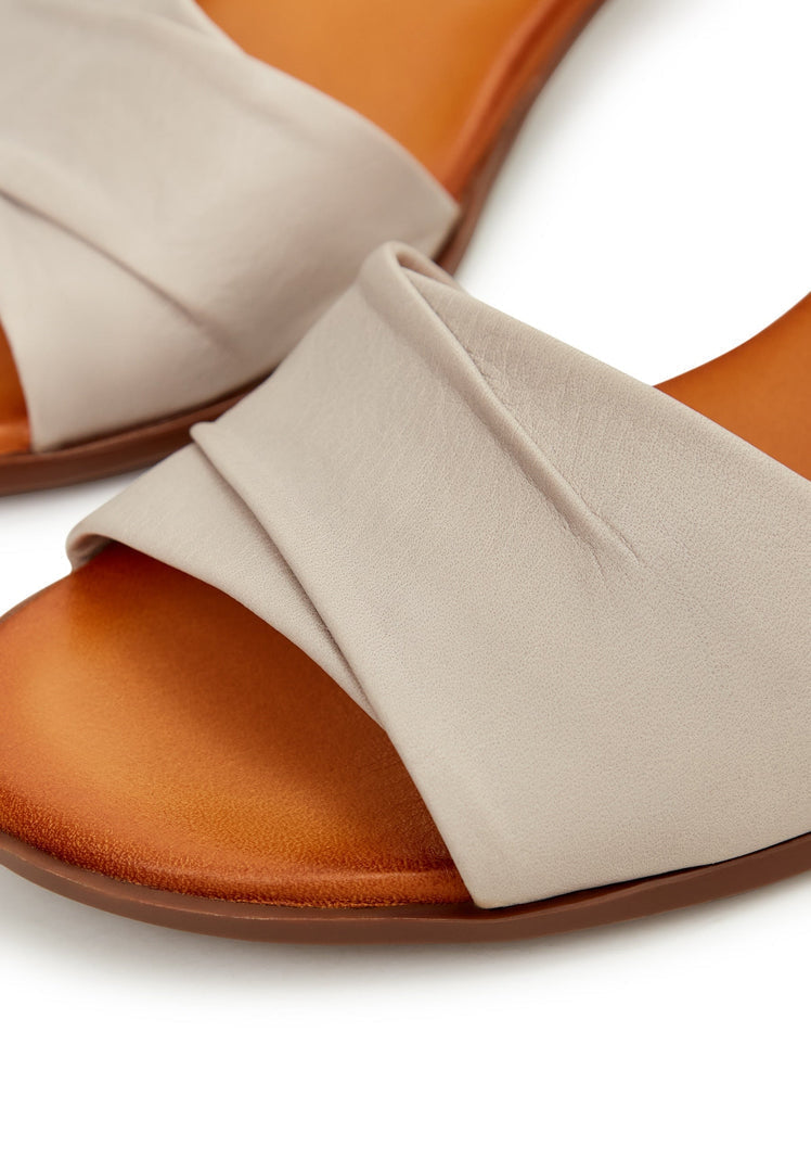 A stylish pair of women's beige block heeled sandals, perfect for a fashionable and comfortable day out.