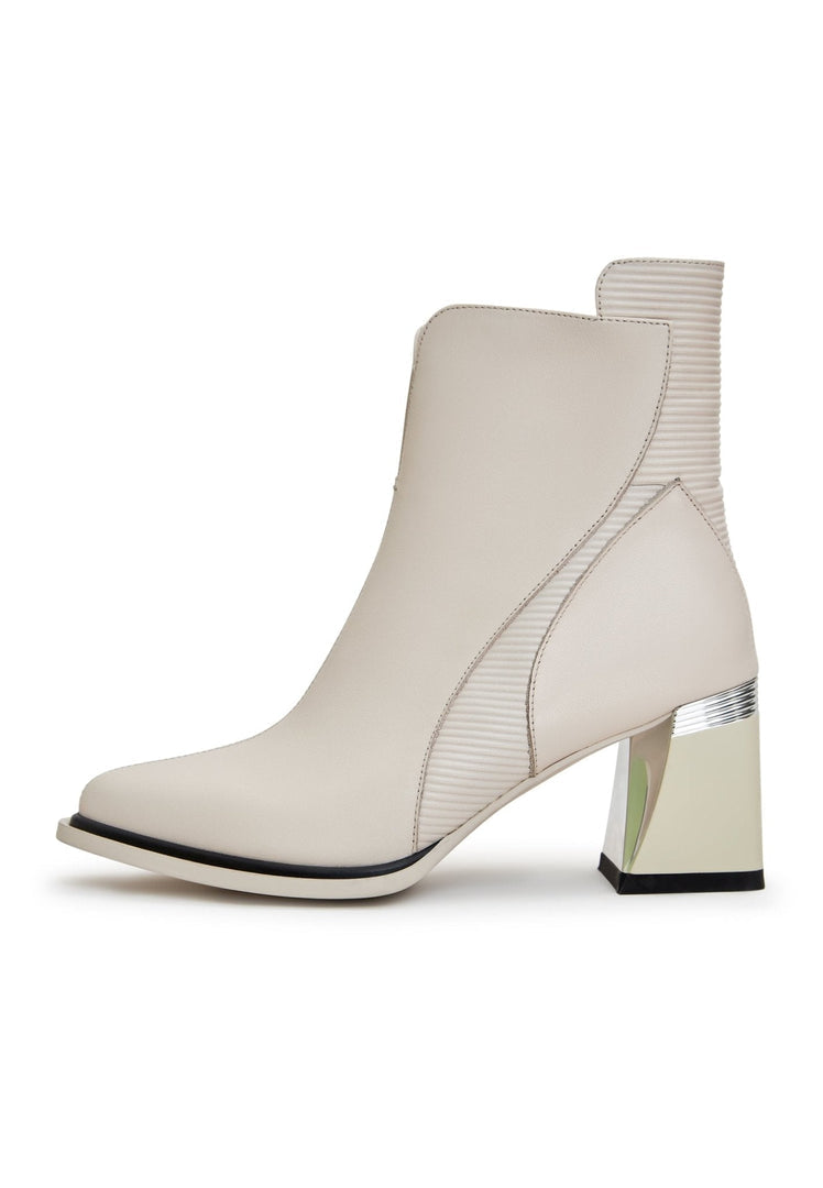 A stylish pair of women's off white block heel ankle boots, featuring a chunky heel and trendy design, perfect for a fashion-forward look.