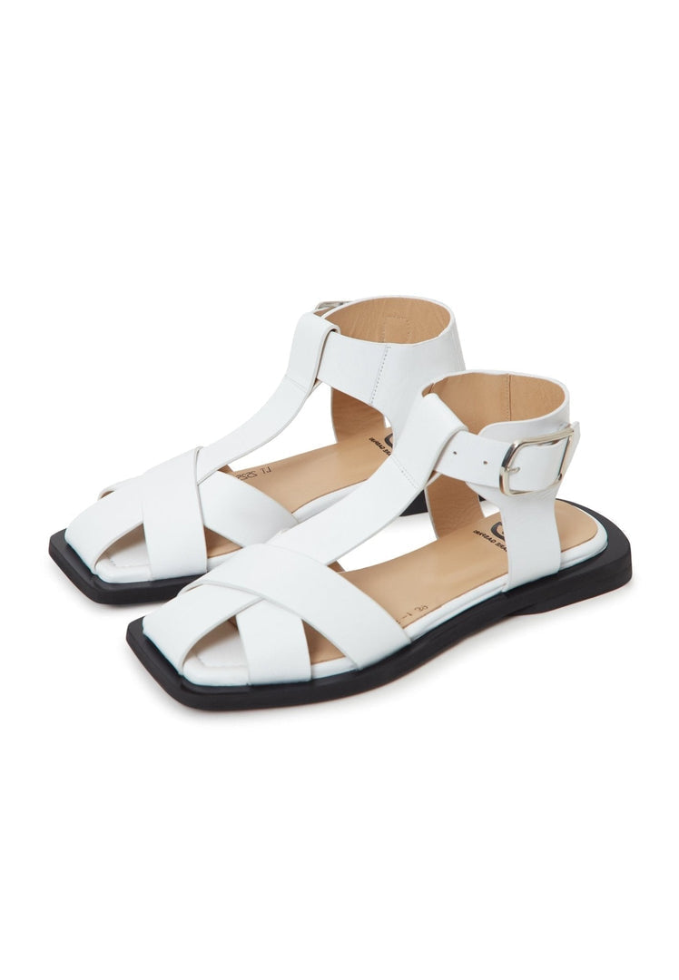 A close-up image of white ankle cuff flat sole sandals for women, perfect for summer footwear.