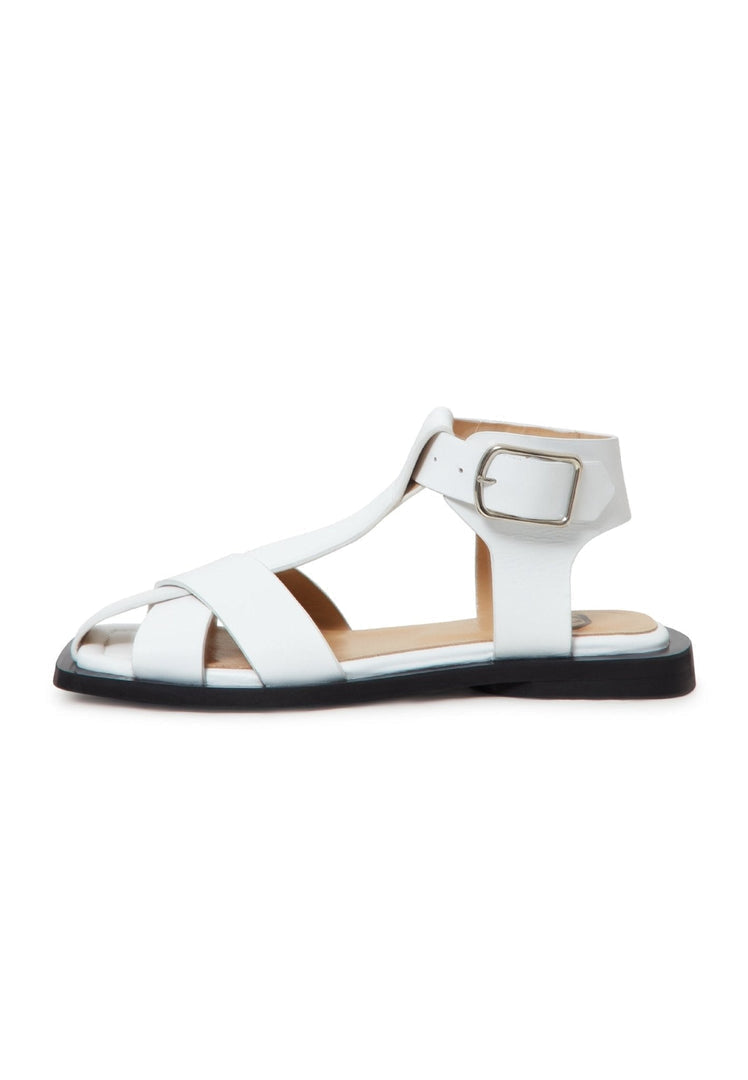 A pair of stylish white ankle cuff sandals with a flat sole for women, perfect for summer footwear.