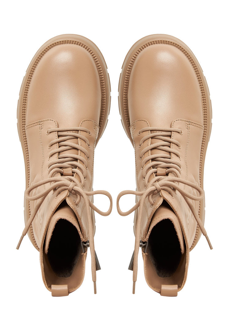 A trendy pair of beige leather ankle platform boots for women, ideal for fashion footwear enthusiasts.