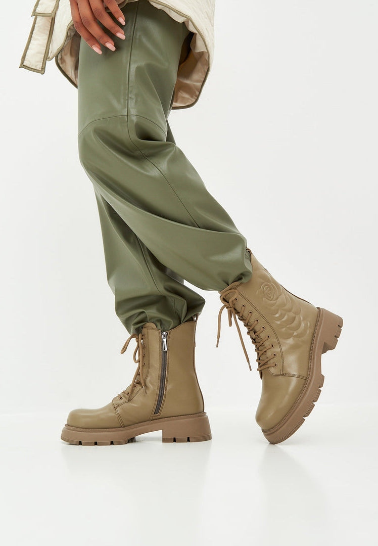 A stylish pair of green leather platform ankle boots, perfect for making a fashion statement.