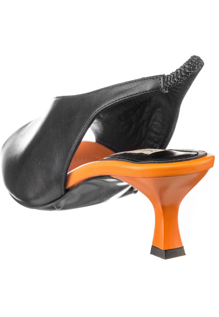 A woman's feet wearing stylish and comfortable slingback sandals - perfect for anyone looking for fashionable yet affordable options.