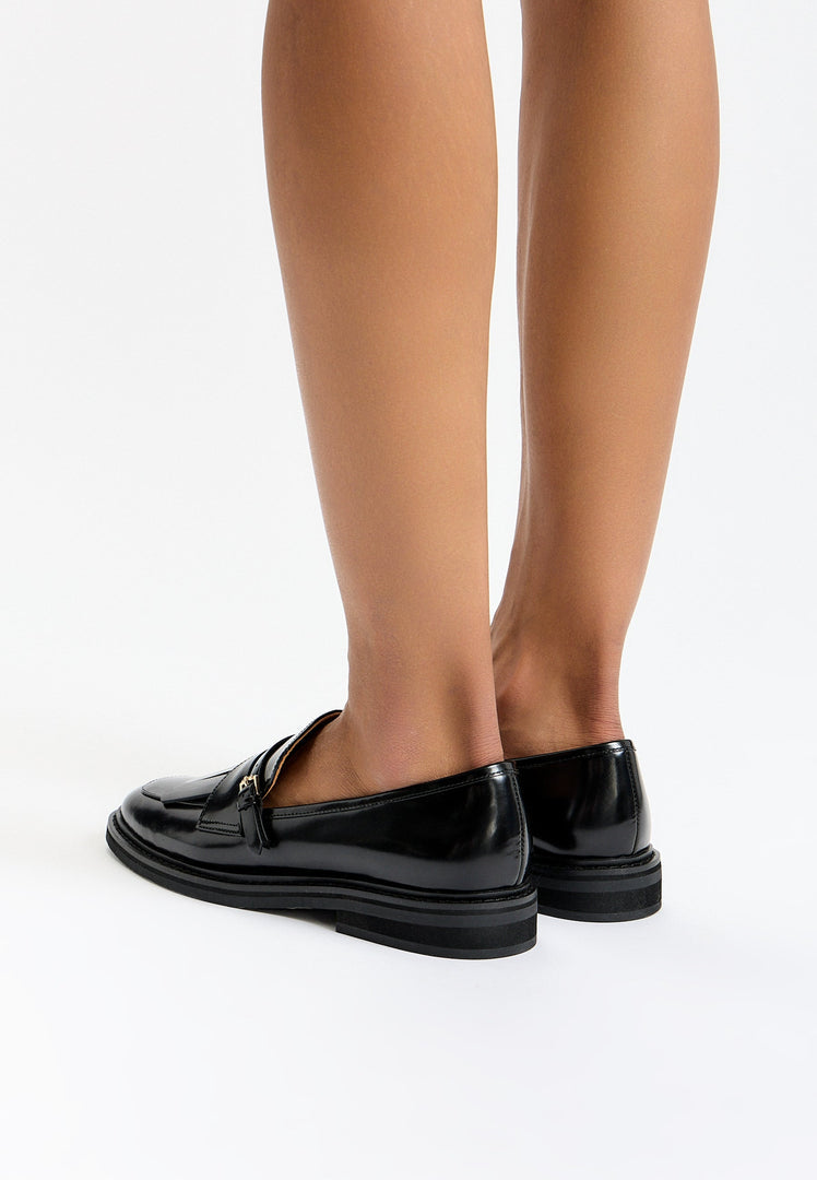 A pair of timeless classic fringe loafers, perfect for a touch of vintage sophistication.