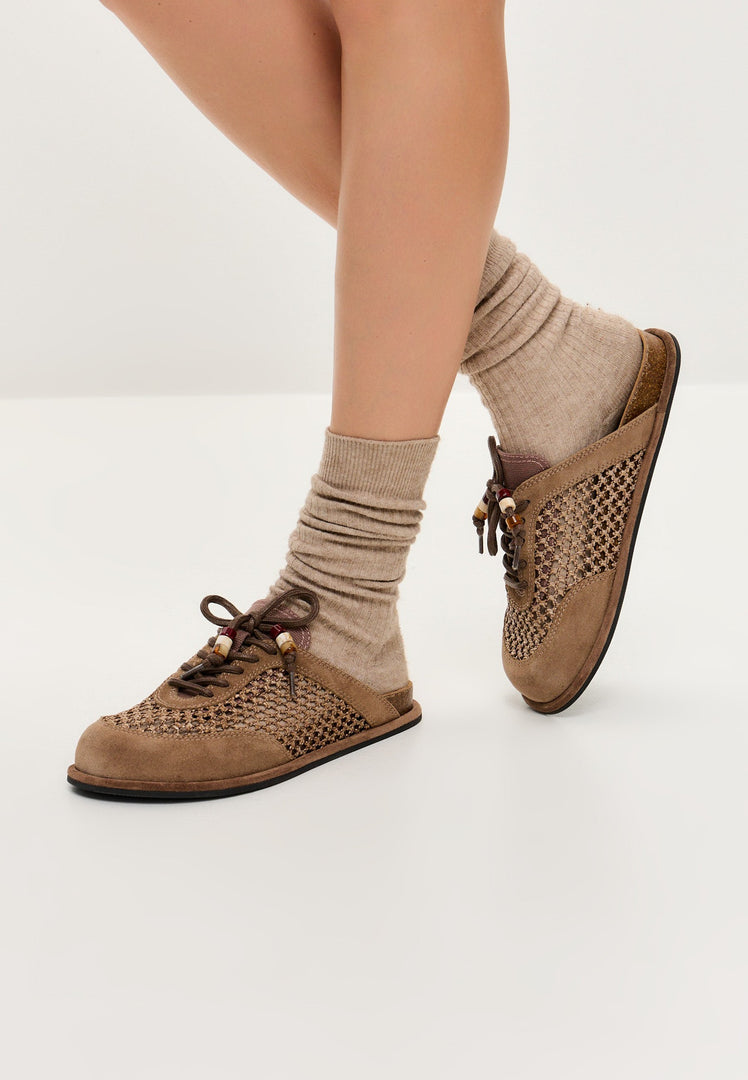 A pair of stylish and comfortable open-back mules, known as Nomad Breeze shoes, perfect slip-on mules for casual and chic footwear looks.