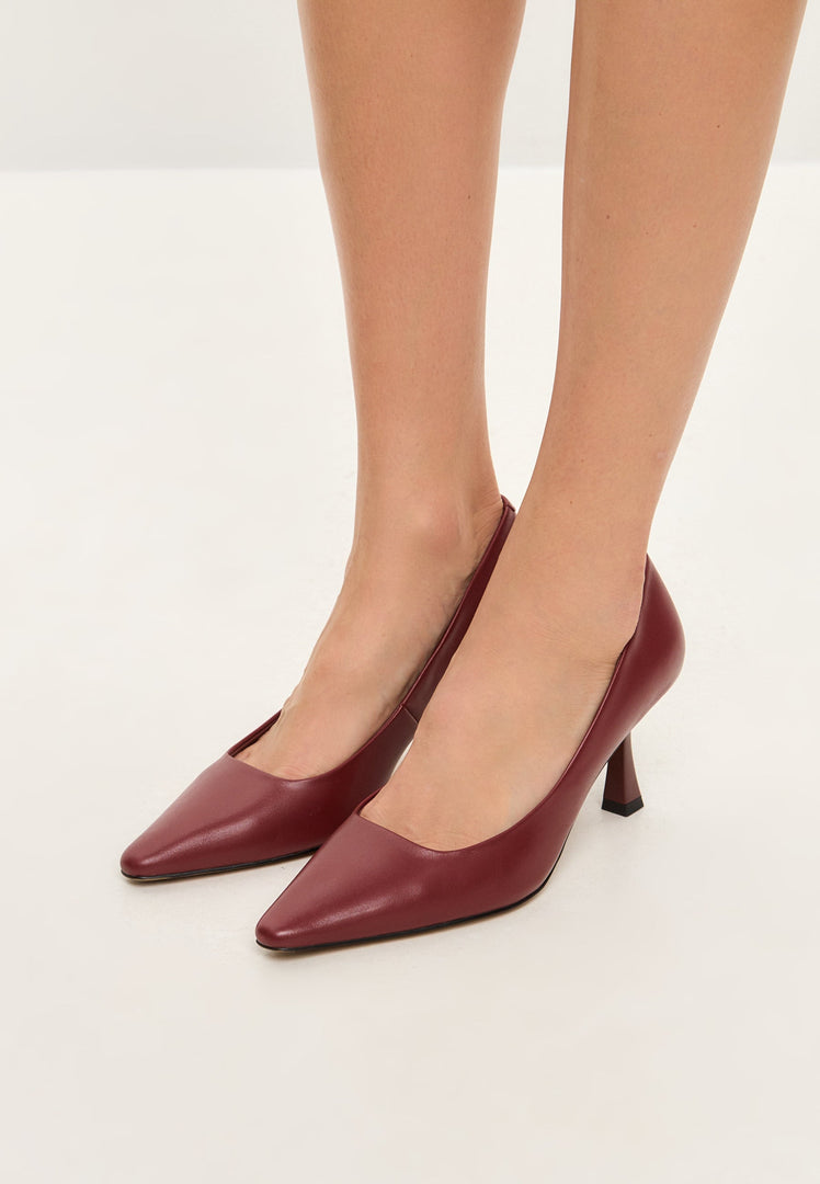 A stylish pair of Bordeaux leather pumps, the epitome of classic elegance and designer footwear with sleek leather heels.