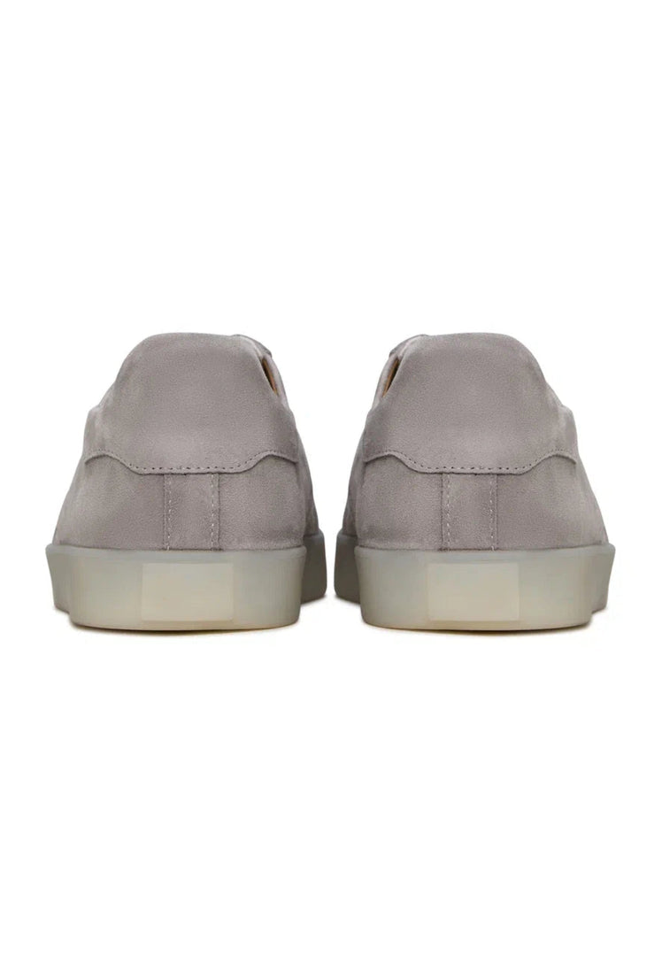A pair of stylish low-top gray suede sneakers, the perfect classic footwear choice for any outfit.