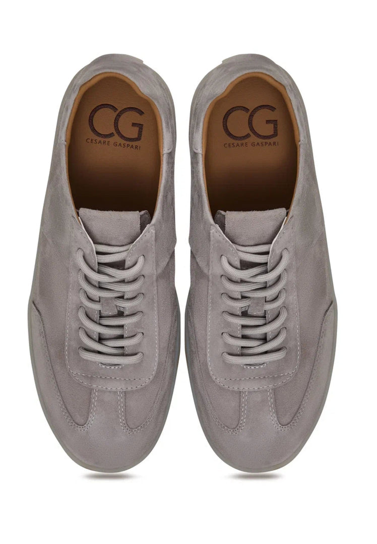 A stylish pair of classic low-top gray suede sneakers, the perfect choice for fashionable footwear enthusiasts.
