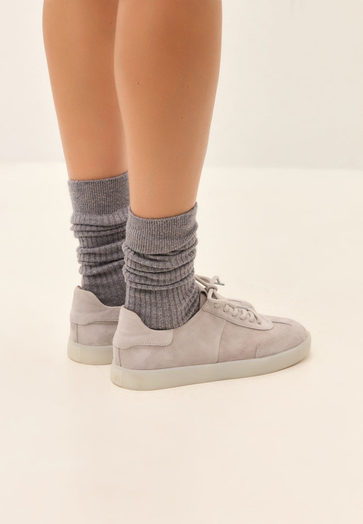 A stylish pair of gray suede low-top sneakers, perfect for a classic and trendy look.