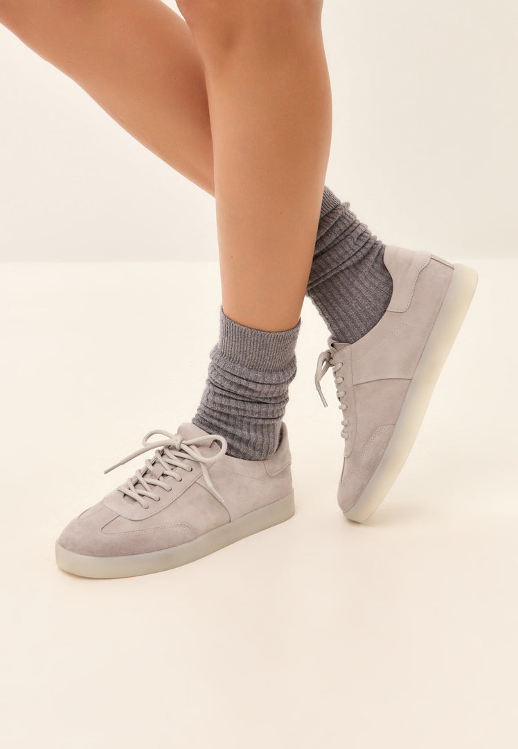 A stylish pair of low-top gray suede sneakers, the perfect classic choice for stylish footwear.
