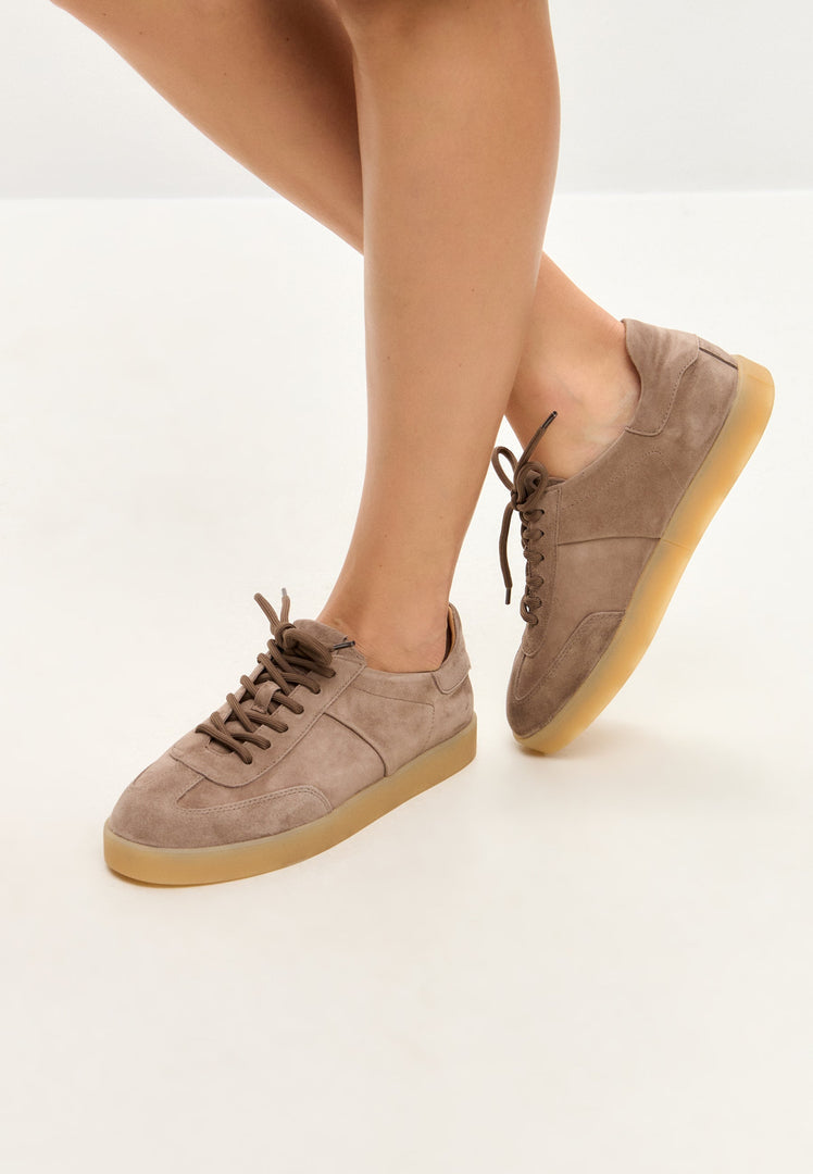 A pair of stylish beige suede low-top sneakers, a classic addition to your footwear fashion collection.