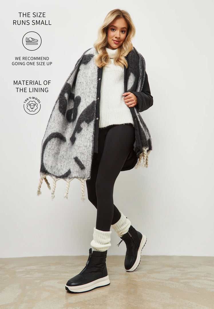 A stylish pair of black platform winter boots, perfect for staying warm and fashionable in the cold weather.