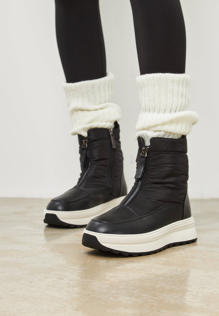 A pair of stylish black platform winter boots, perfect for staying warm and fashionable during the cold season.