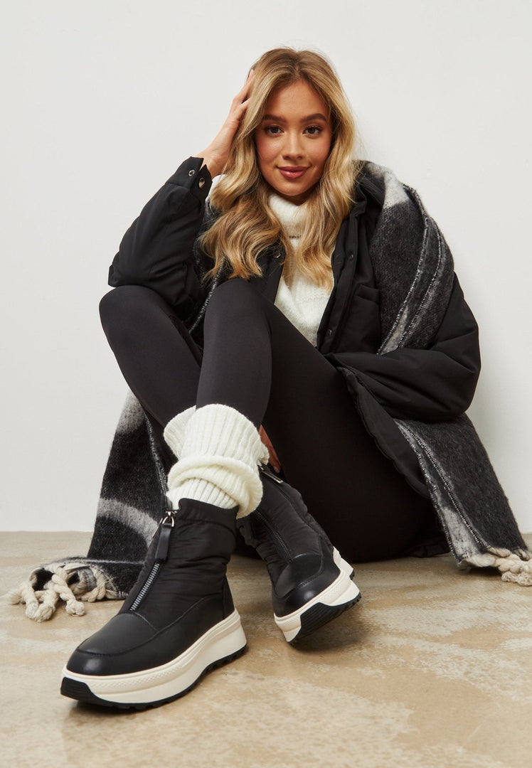 A pair of stylish black platform winter boots for ultimate warmth and fashion-forward style.