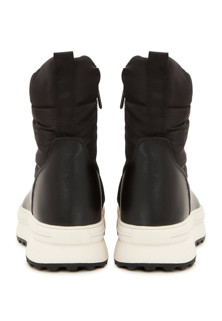A stylish pair of black platform winter boots, perfect for staying warm and fashionable during the cold season.