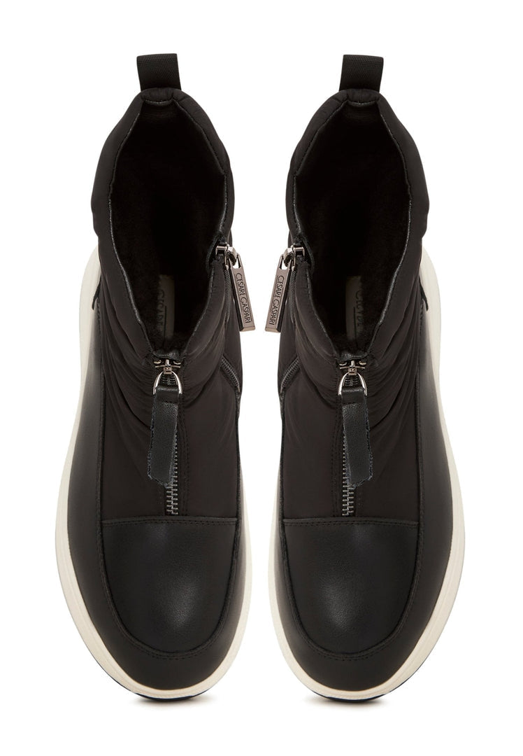 A stylish pair of black platform winter boots, perfect for staying warm and fashionable during the cold season.