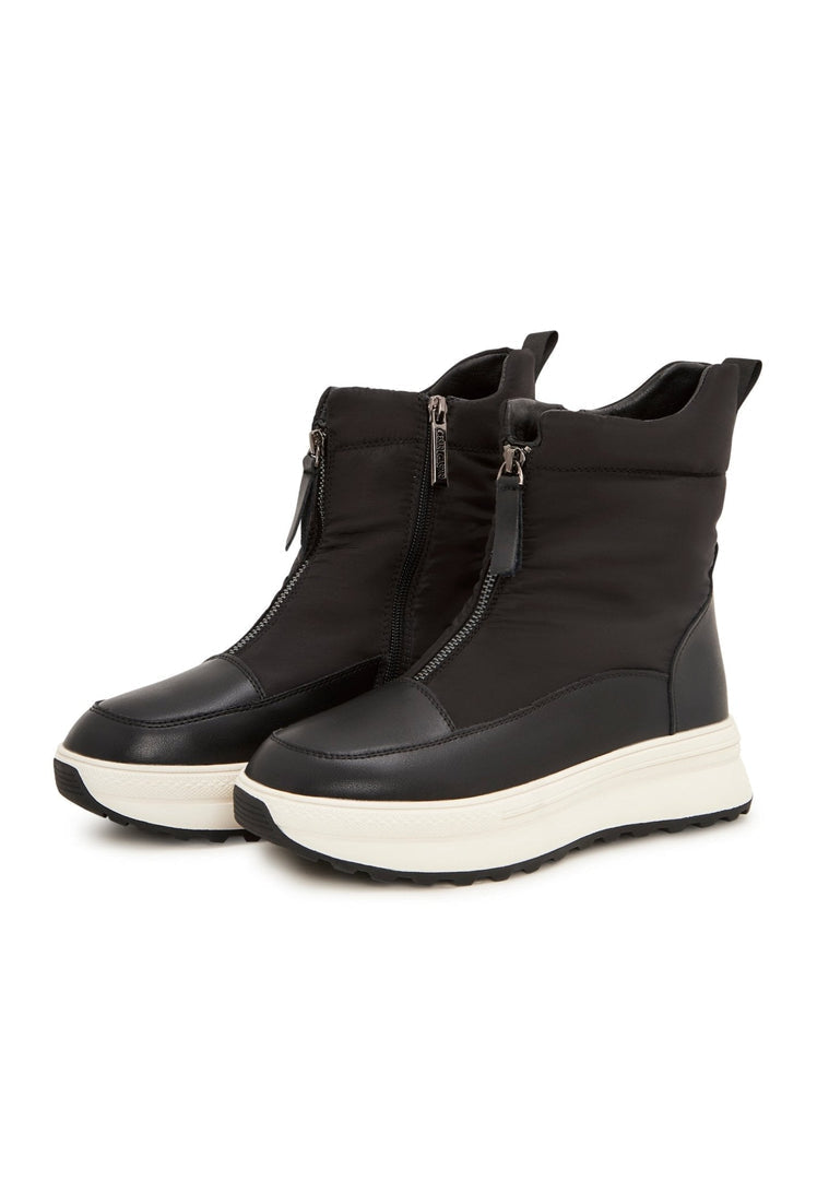 A pair of stylish black platform winter boots, perfect for staying warm and on-trend during the cold season in a snowy setting.