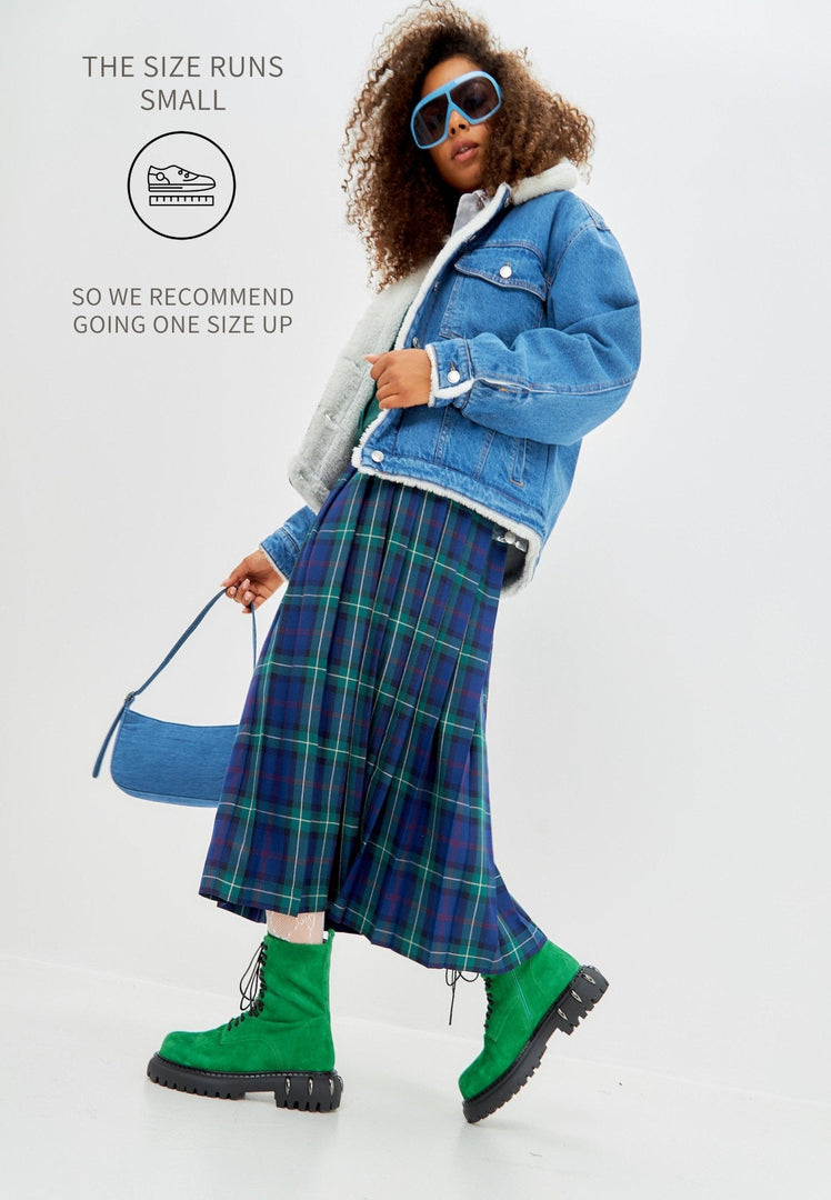 A pair of stylish green lace-up combat boots with a chunky sole, perfect for adding a military-inspired flair to women's fashion footwear.