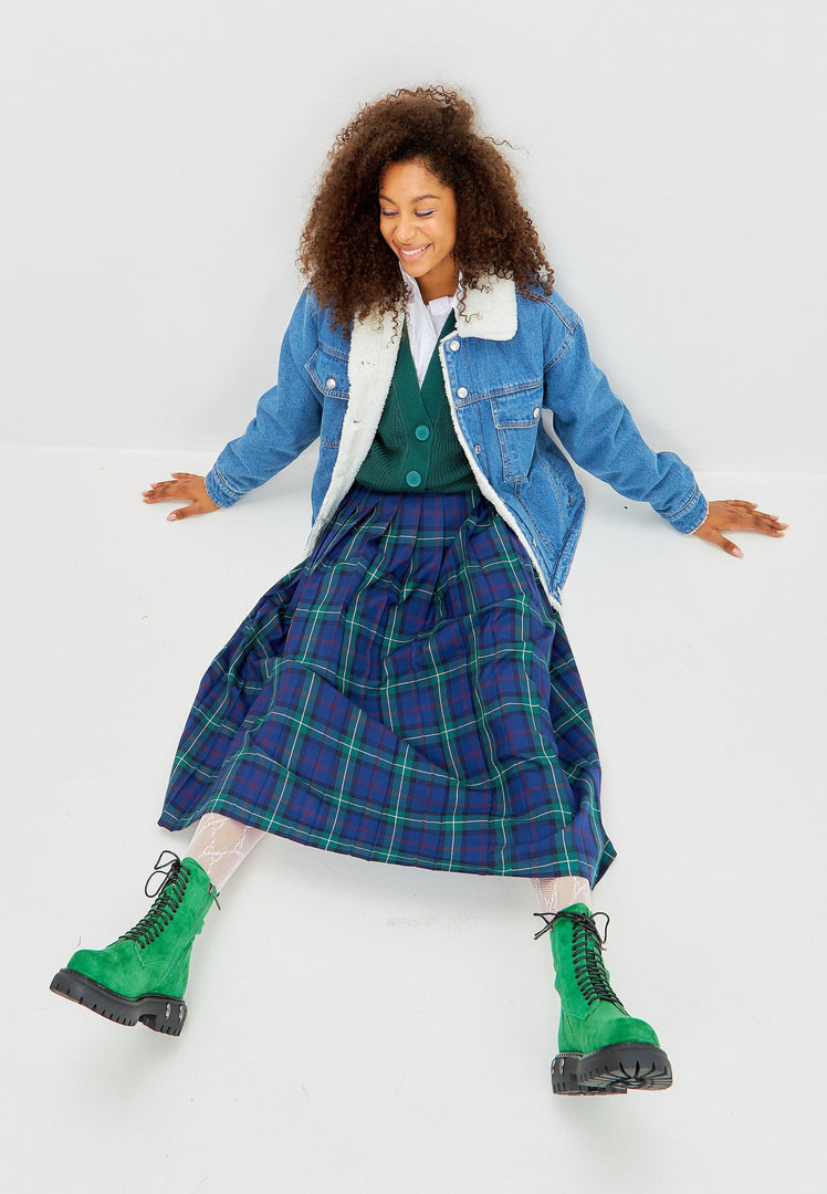 A stylish pair of lace-up combat boots with a chunky sole in green, perfect for those looking for military-style women's fashion footwear.