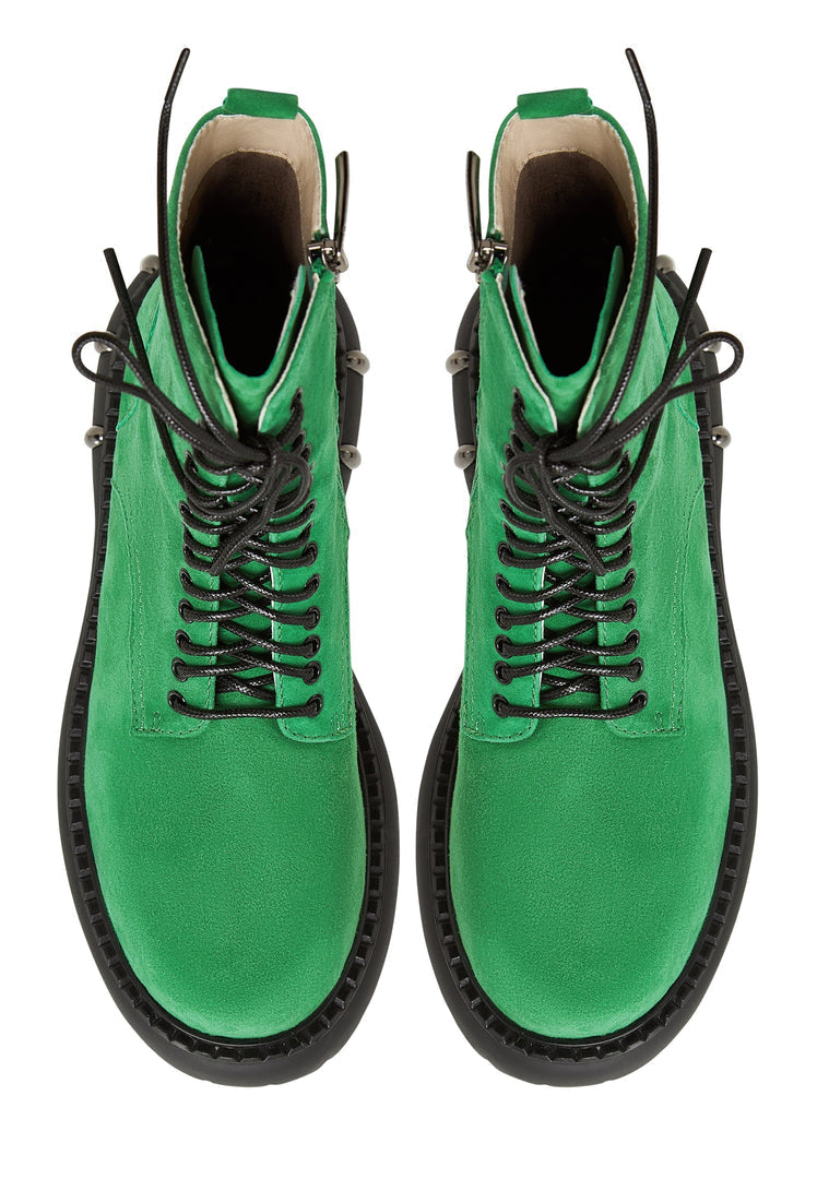 A pair of stylish lace-up combat boots with a chunky sole in green, perfect for women's fashion footwear with a military-style touch.