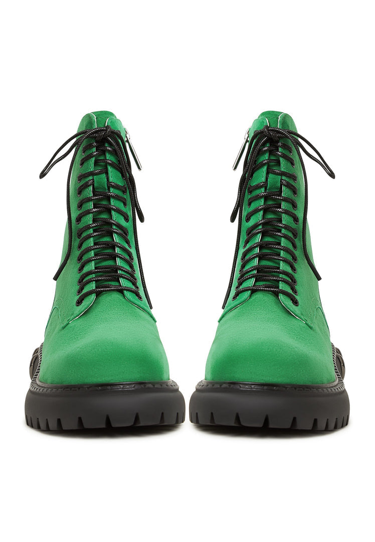 A stylish pair of women's lace-up combat boots in green with a chunky sole, ideal for those who love military style footwear trends.