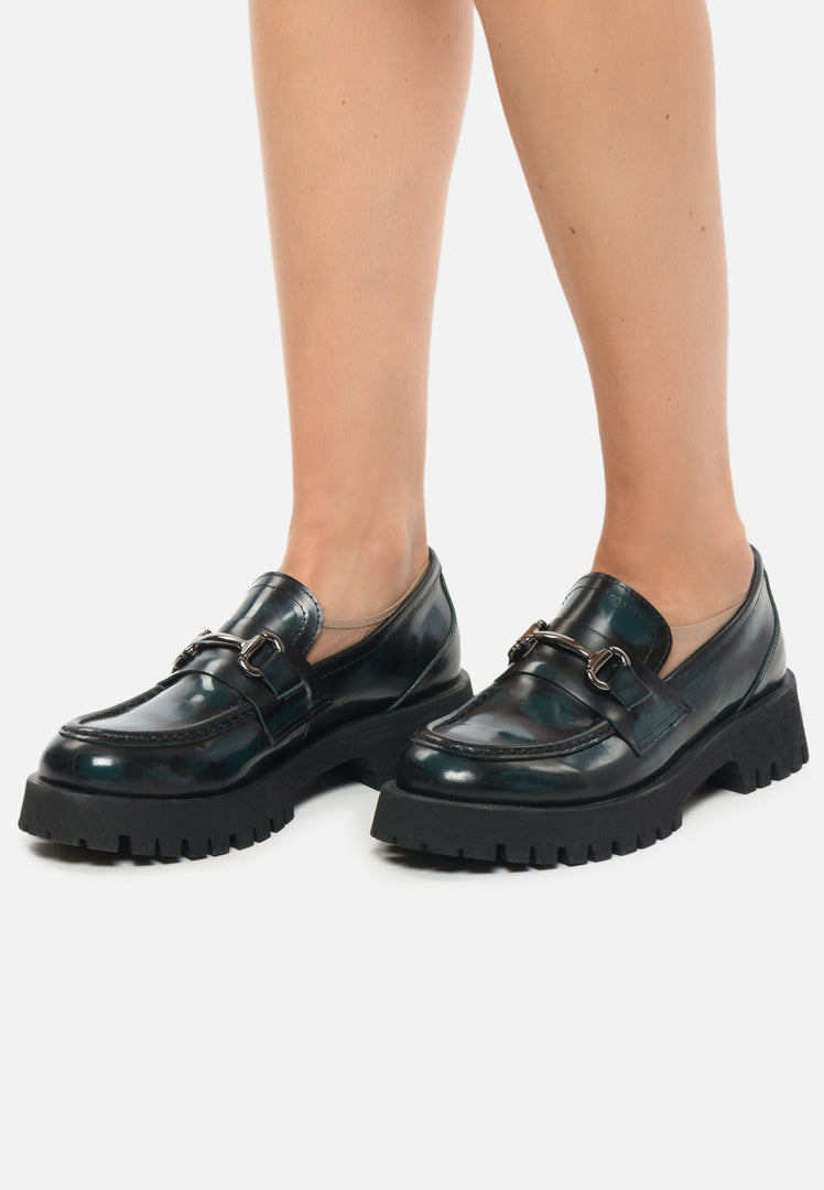 A stylish pair of luxury women's shoes in dark green, featuring gold-bit loafers and luxe glide Josephine loafers.