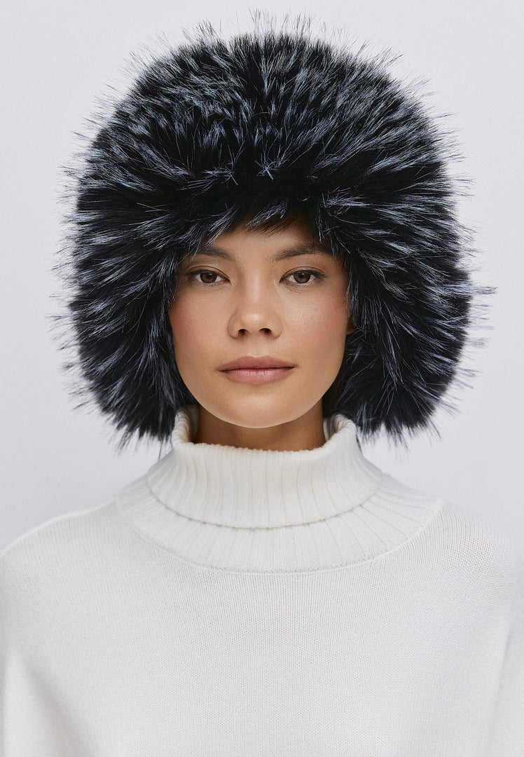 Woman wearing a stylish blue faux fur hat, perfect for winter fashion and warmth.